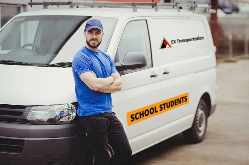 Driver leaning on an EX Transportation school students van